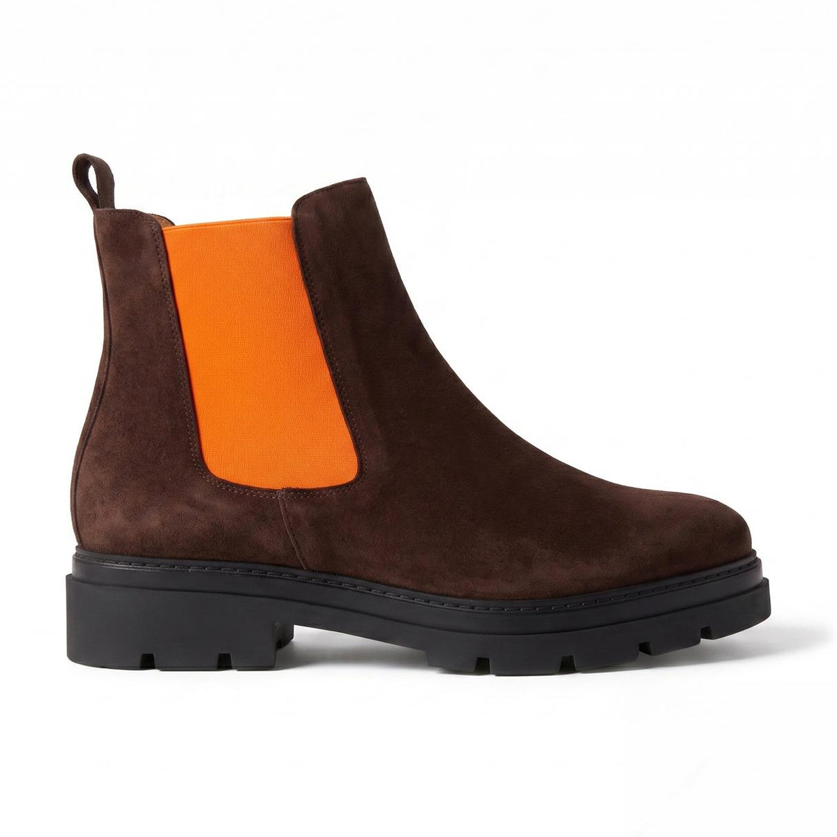 A dark brown suede Chelsea boot with a bright orange elastic side panel and a chunky black lug sole, shown in profile against a white background.