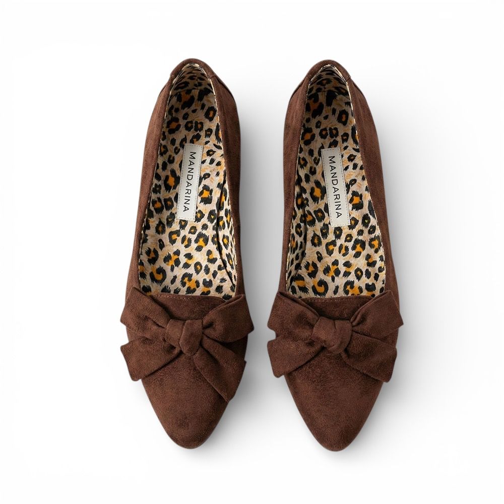Brown shoes with leopard print lining on a white background