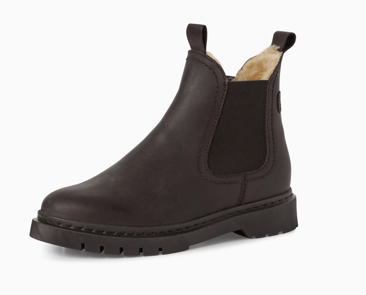 Brown leather Chelsea boot with fur lining on a white background