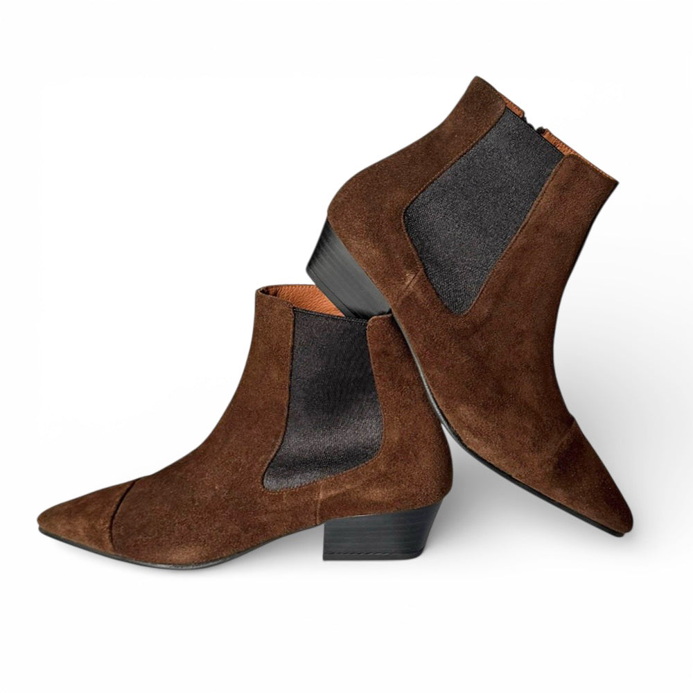 Pair of brown suede ankle boots with black soles on a white background