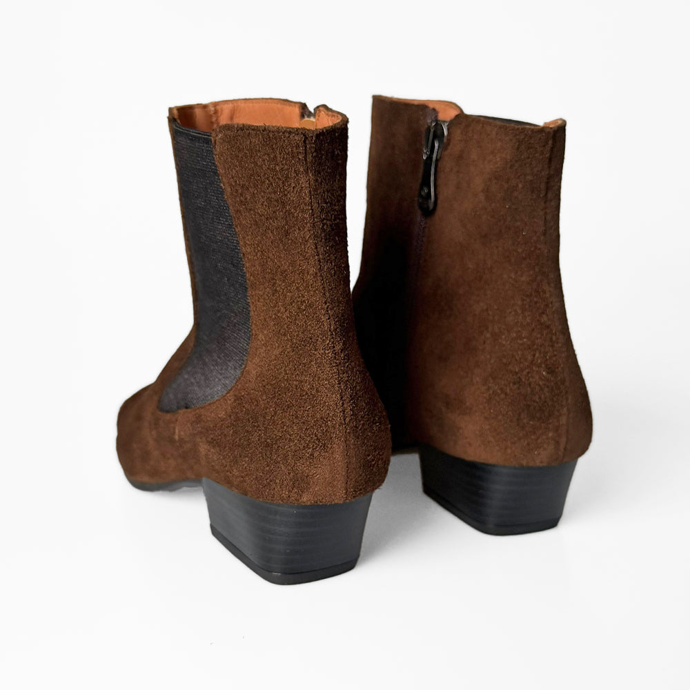 Pair of brown suede boots with black cuban heels on a white background