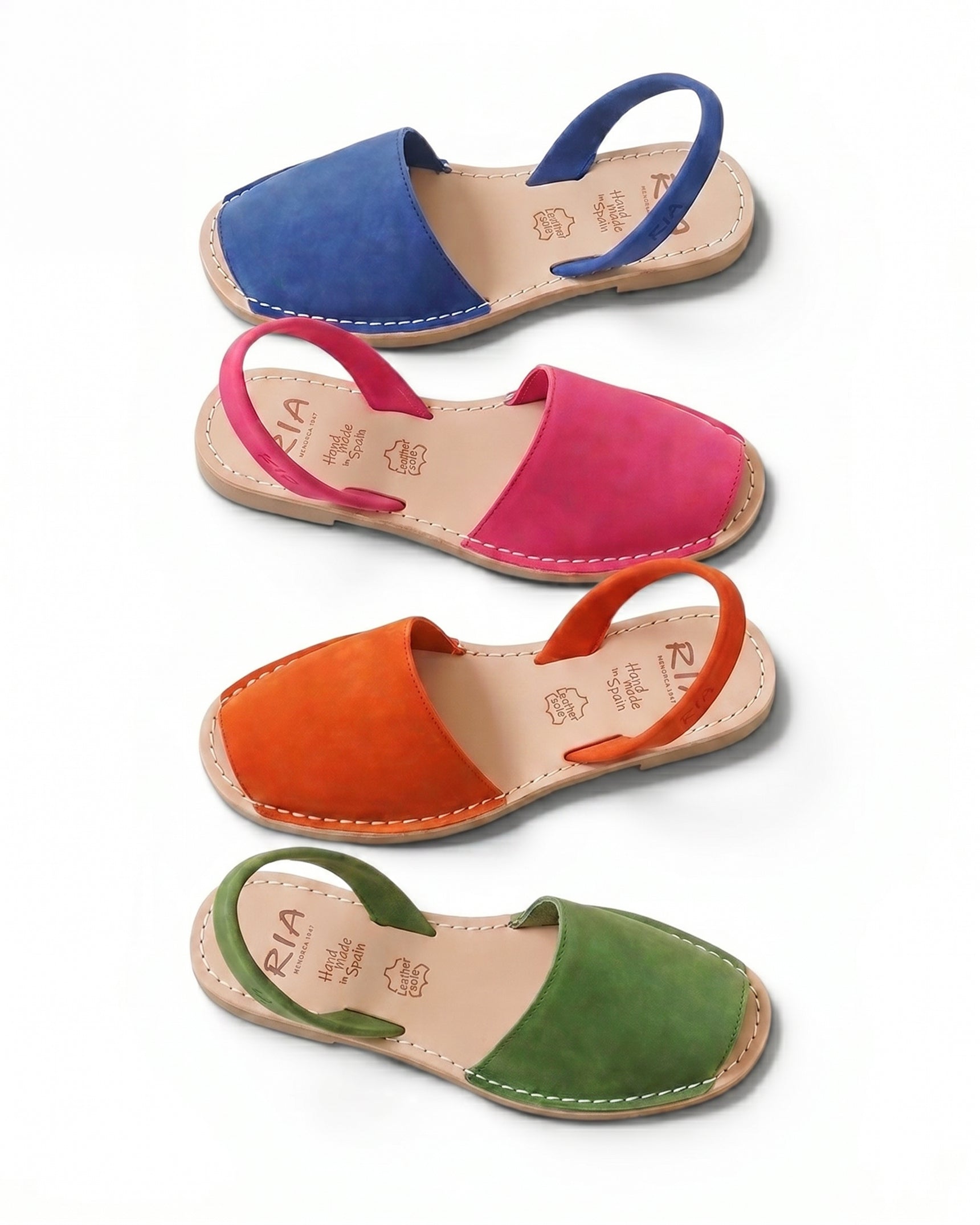 Set of colourful Traditional Ria Avarca Menorcan sandals in blue, pink, orange, and green on a white background