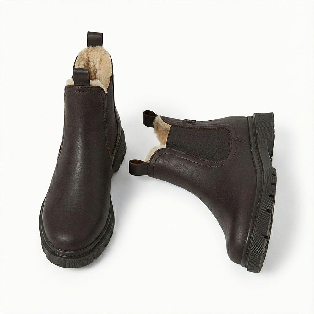 Pair of brown leather boots with fur lining on a white background
