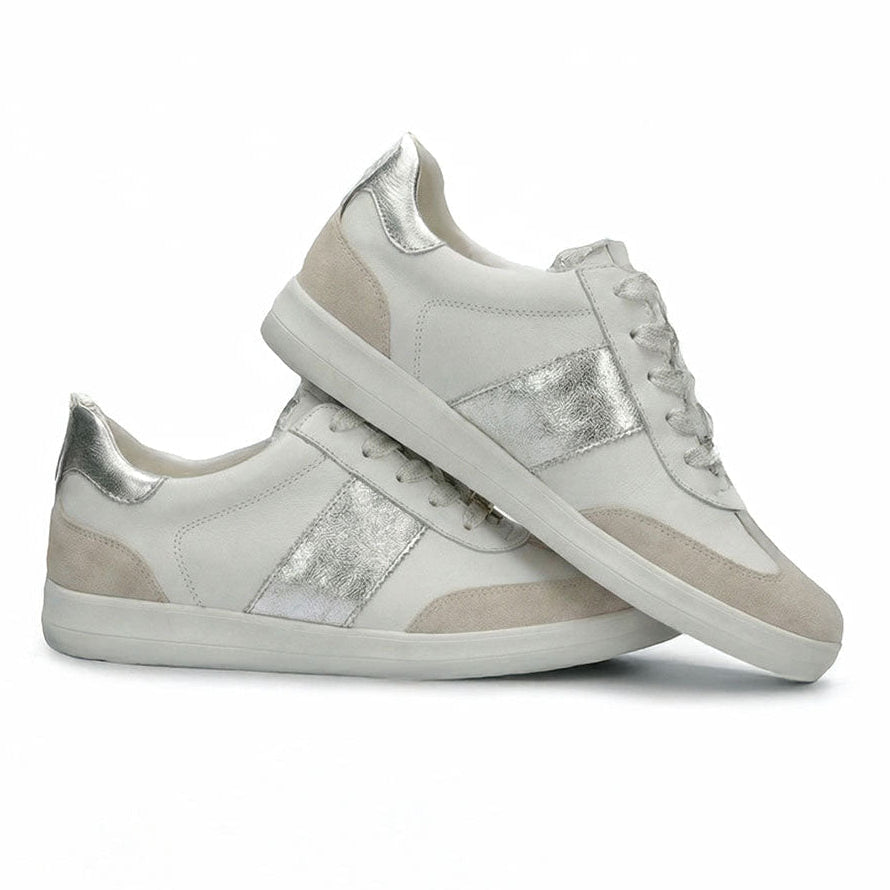 White sneakers with silver accents on a white background