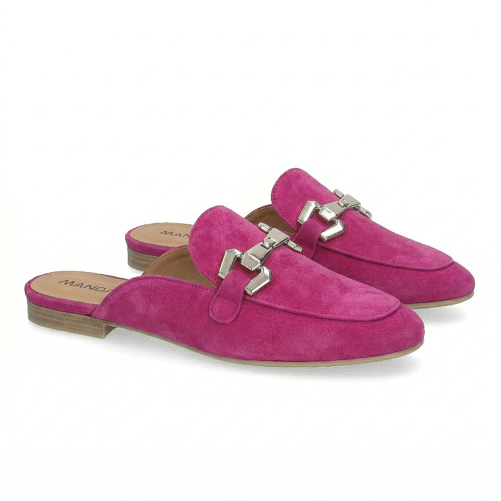 Pair of hot pink suede mules with silver buckles on a white background