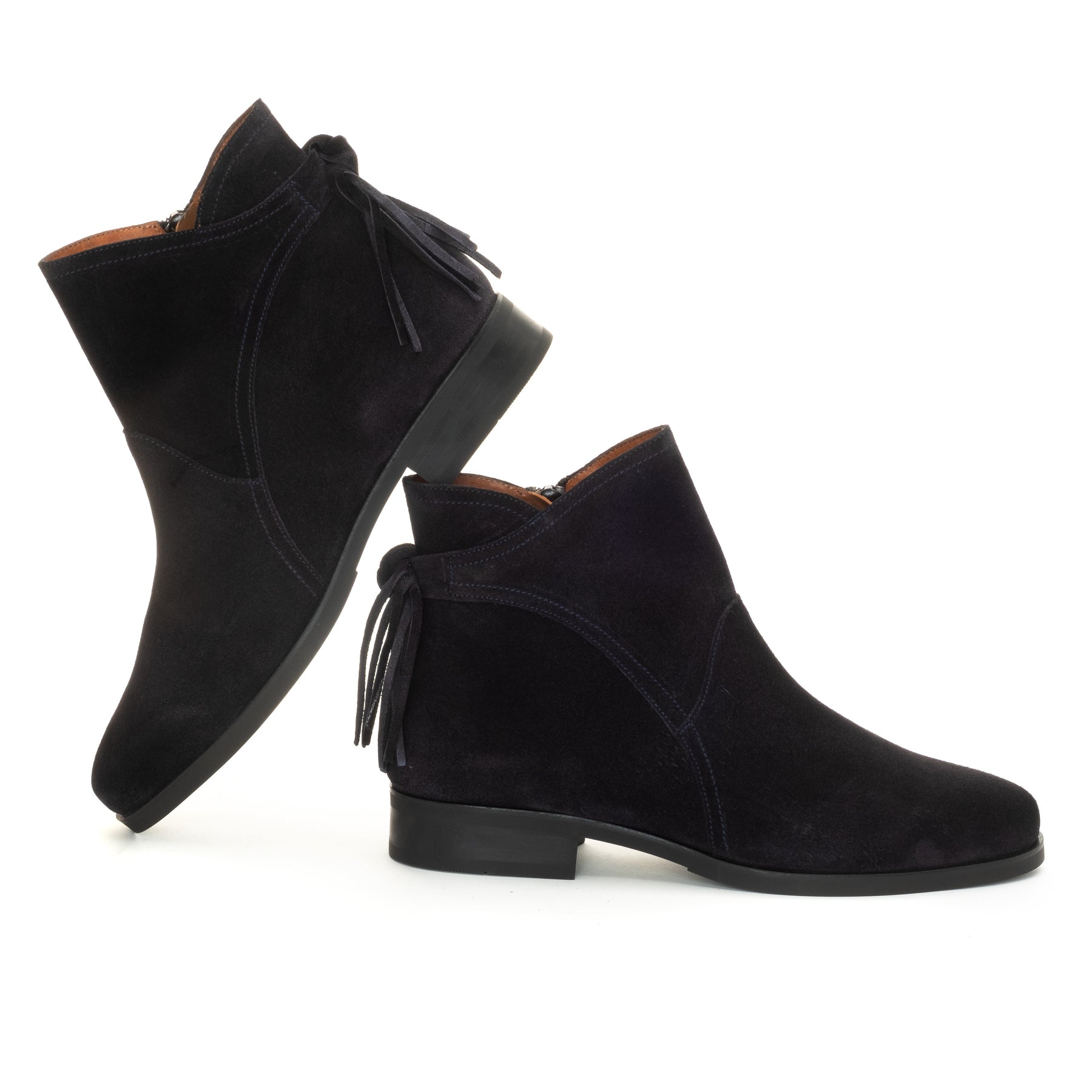 A pair of navy blue suede ankle boots with tassel details, shown from the side and back angles on a plain white background.